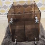 Michel Dumas smoked Plexiglas rolling table.