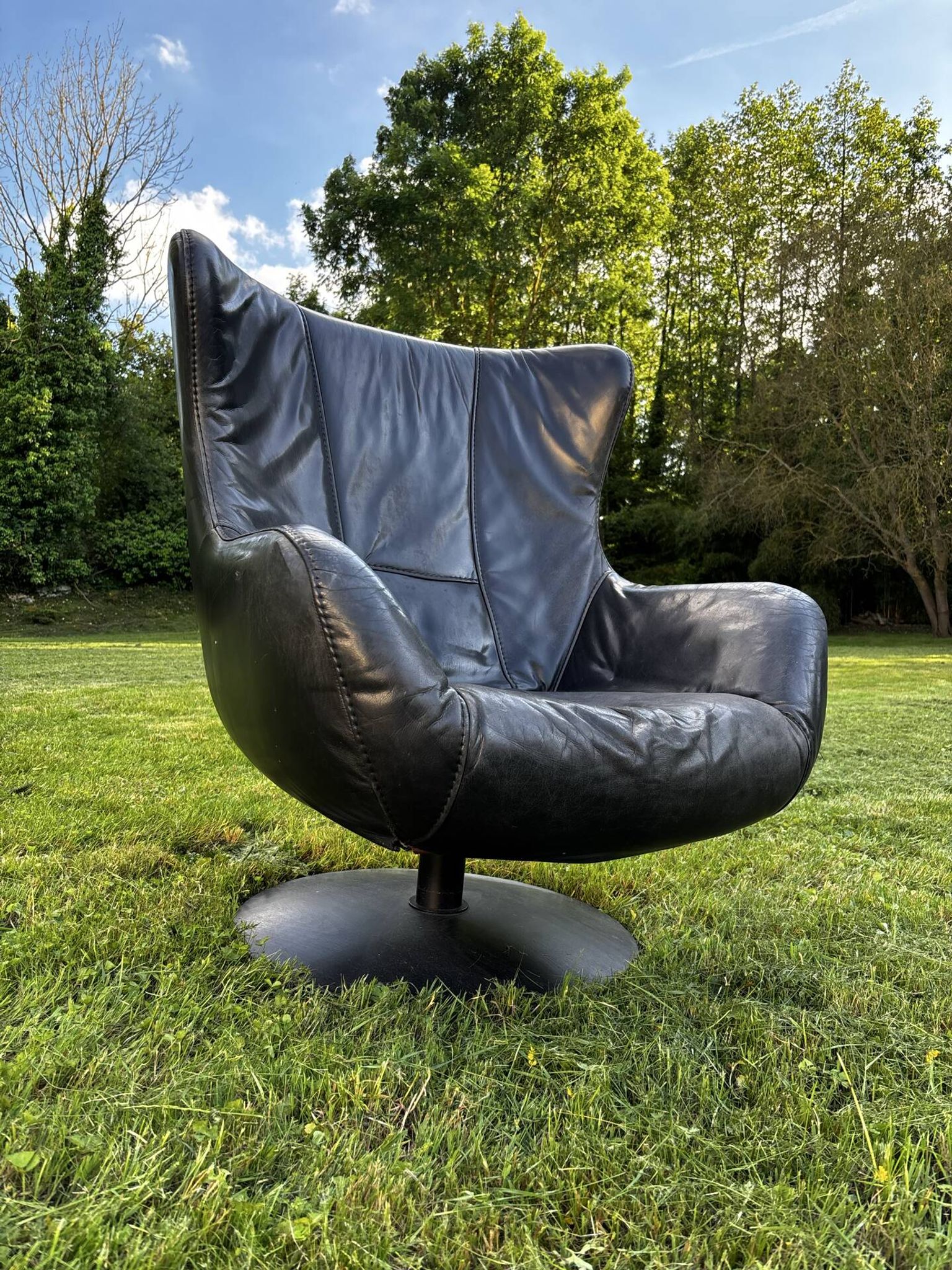 Egg chair style armchair and its ottoman.
