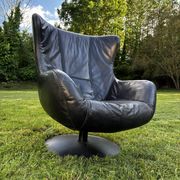 Egg chair style armchair and its ottoman.