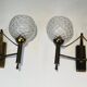 Pair of brass wall lights with glass globes. Around 1970.