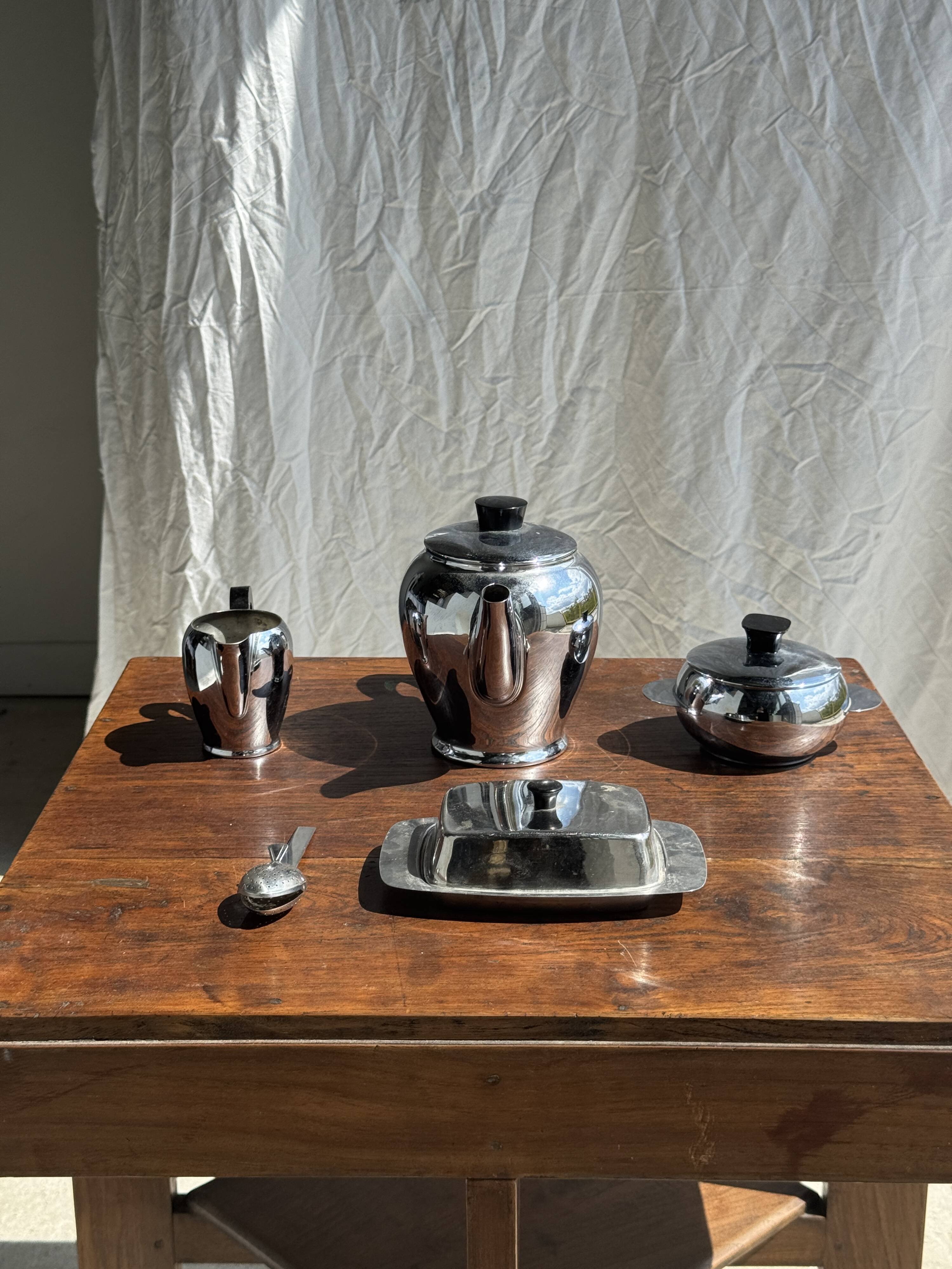 Tea set including teapot, milk jug, sugar bowl and butter dish