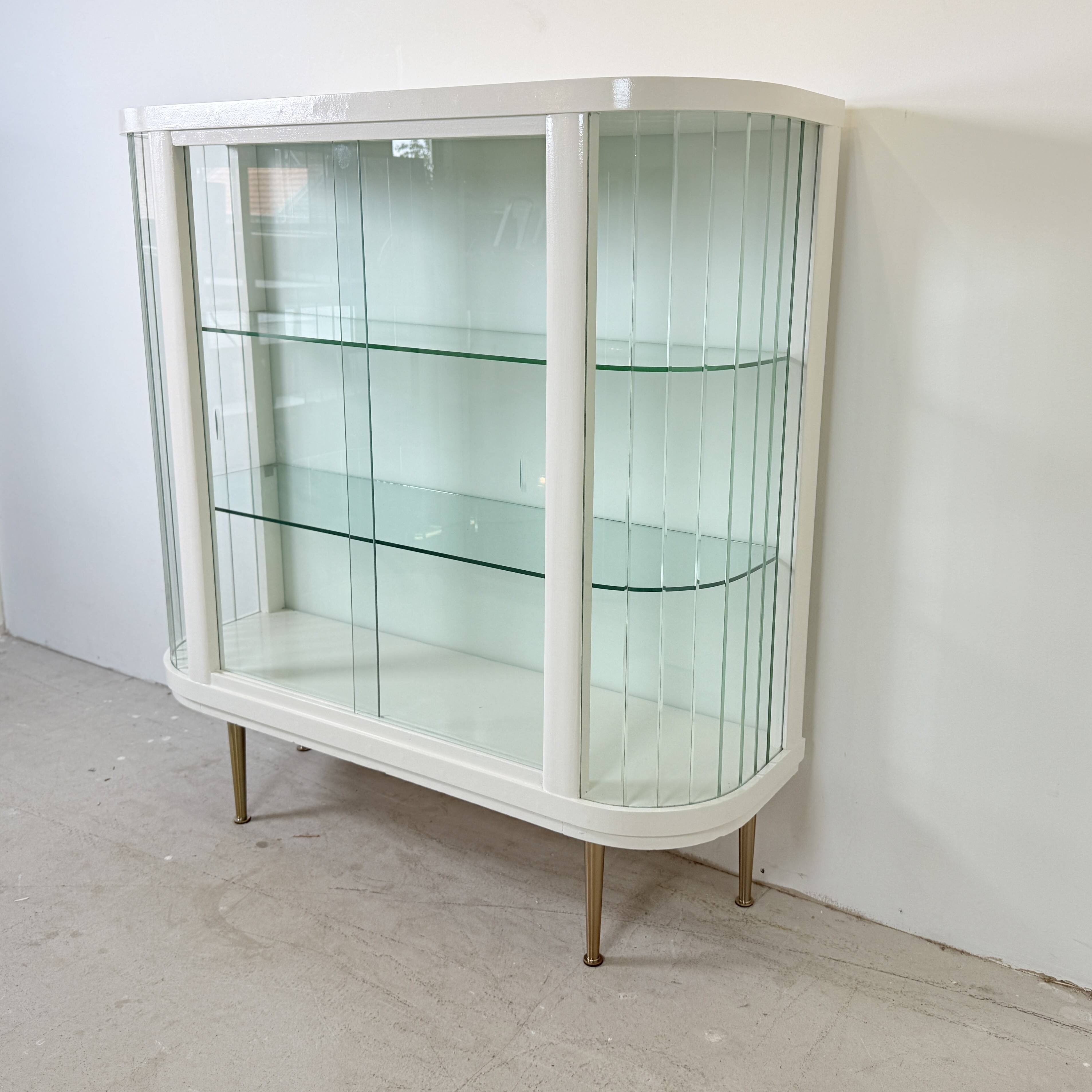 White vintage slatted display case on gold legs