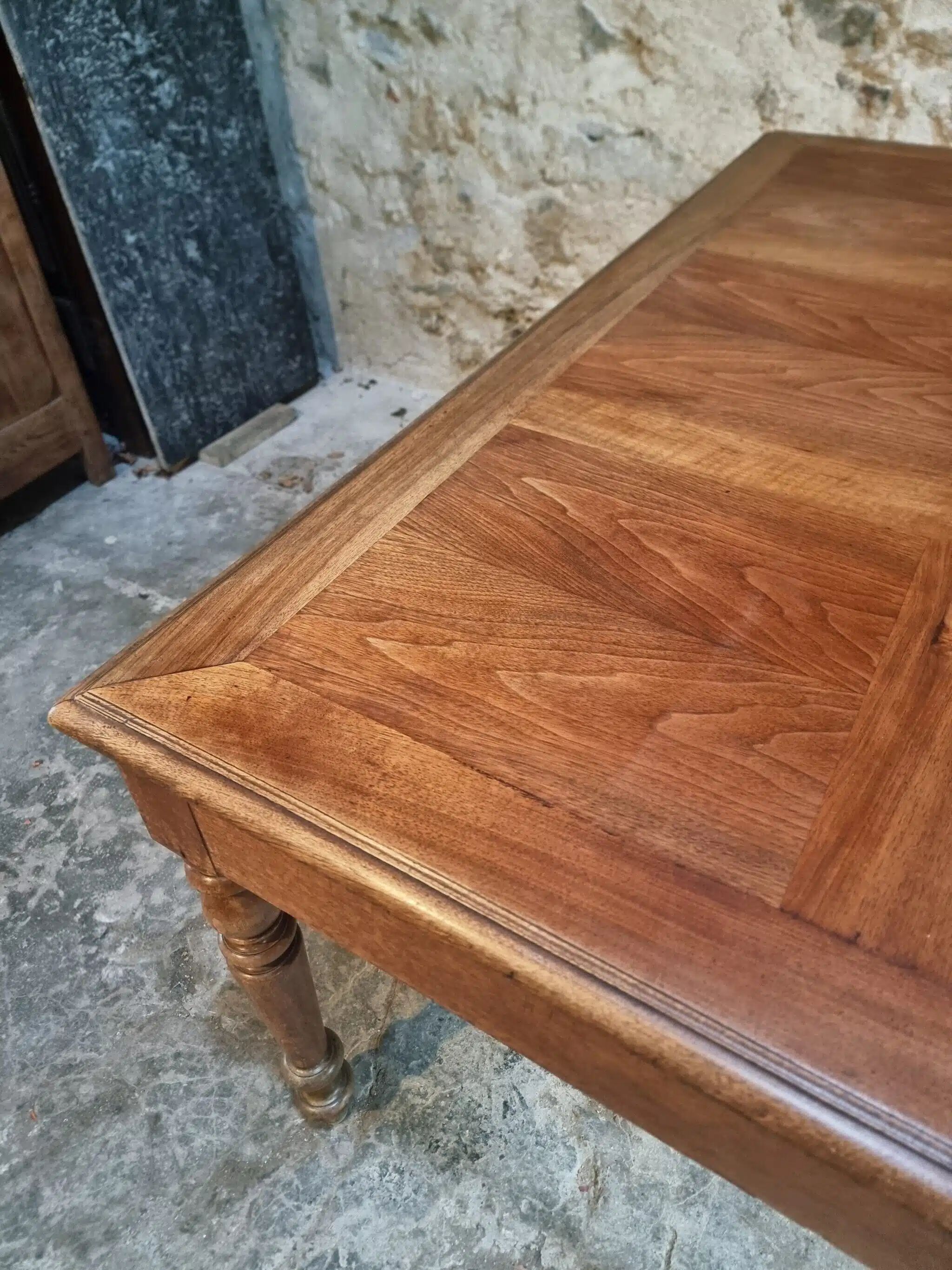 Antique French walnut table with six drawers, parquet top, early 20th century.
