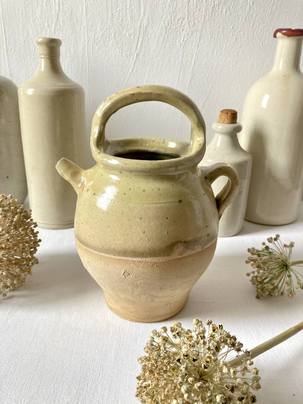 Old small goat-shaped jug in ochre glazed stoneware.