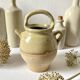 Old small goat-shaped jug in ochre glazed stoneware.