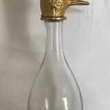 Glass bottle type carafe with gold metal bird head stopper