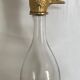 Glass bottle type carafe with gold metal bird head stopper