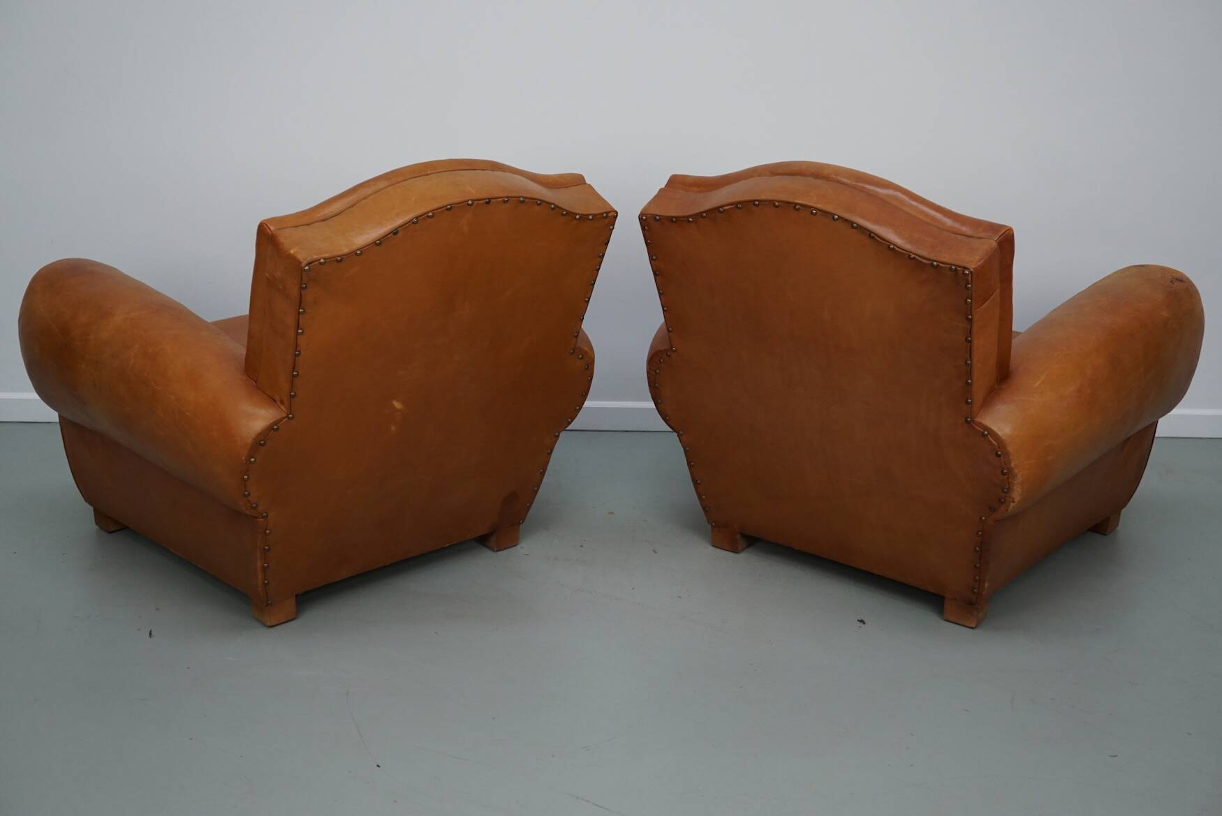 Pair of French club chairs with moustache back in cognac leather, 1950s