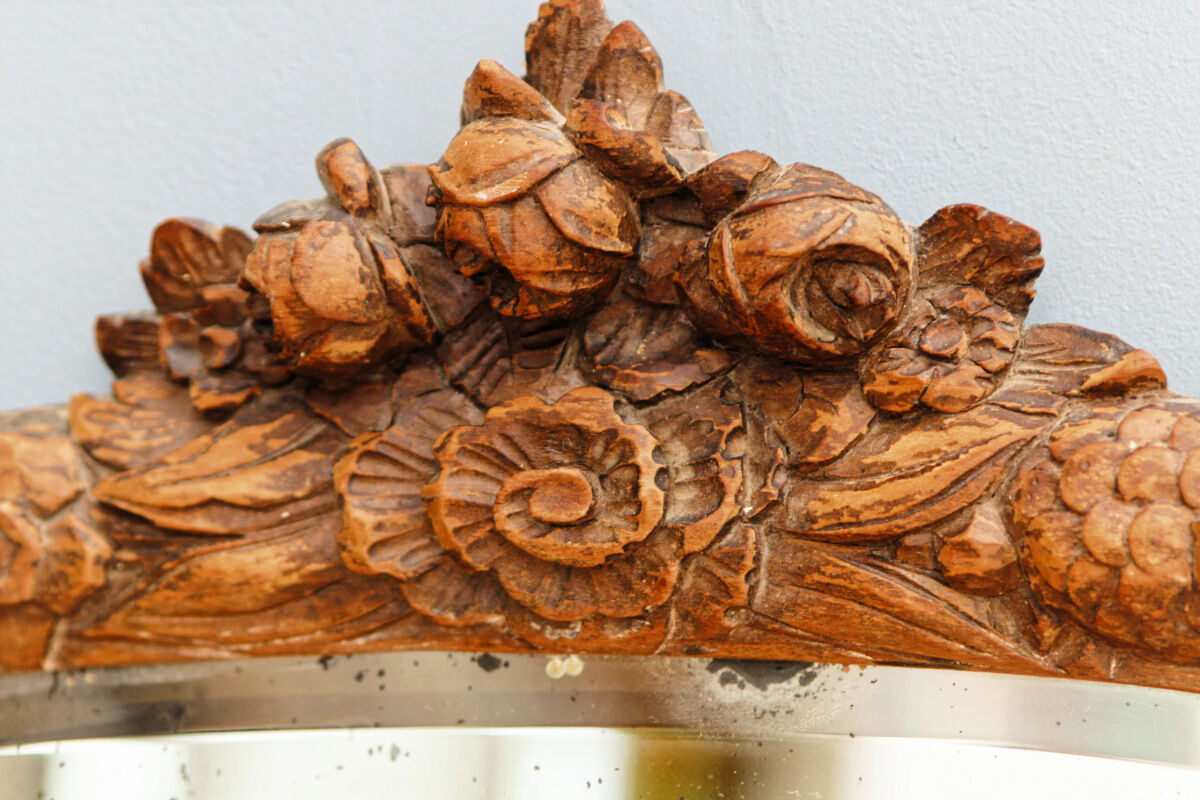 Beveled mirror in carved wood