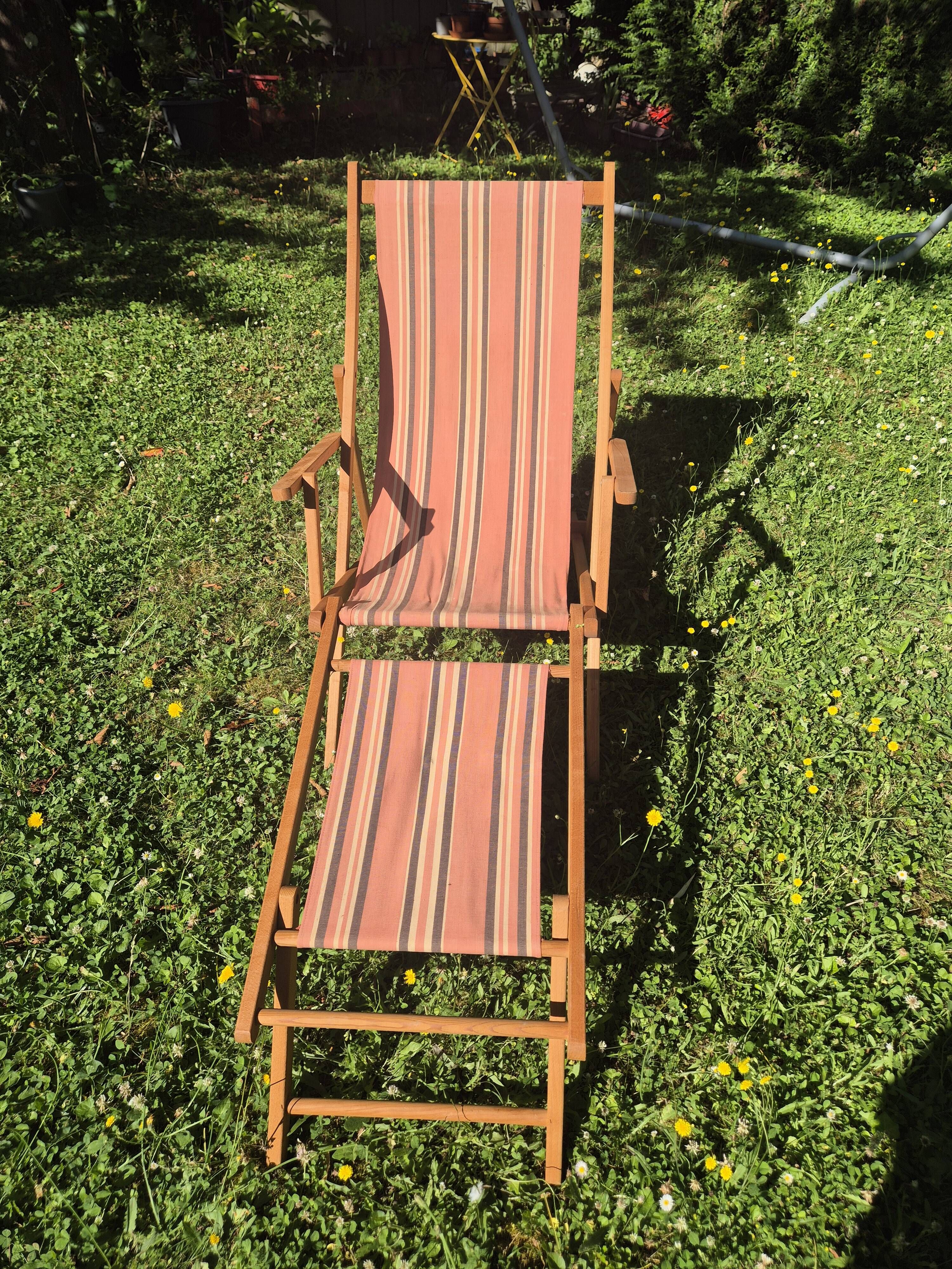vintage wooden deck chair with striped fabric and footrest