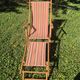 vintage wooden deck chair with striped fabric and footrest