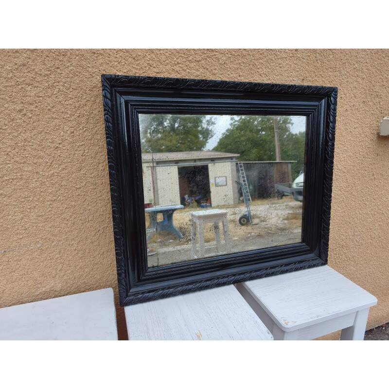 Black lacquered wood mirror "originally punctured"