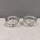 A set of iittala candle holders in clear transparent glass.