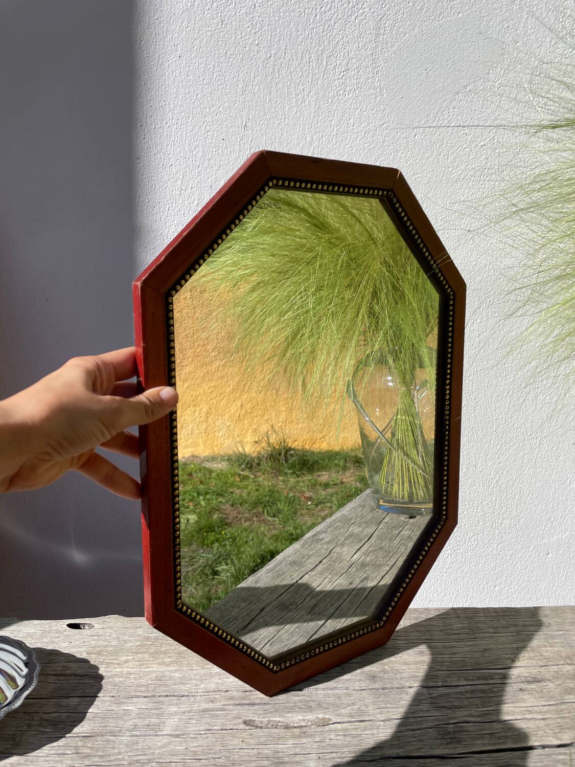 Octagonal beaded wooden mirror