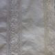 Linen sheet bordered by a wide lace and between two of lace