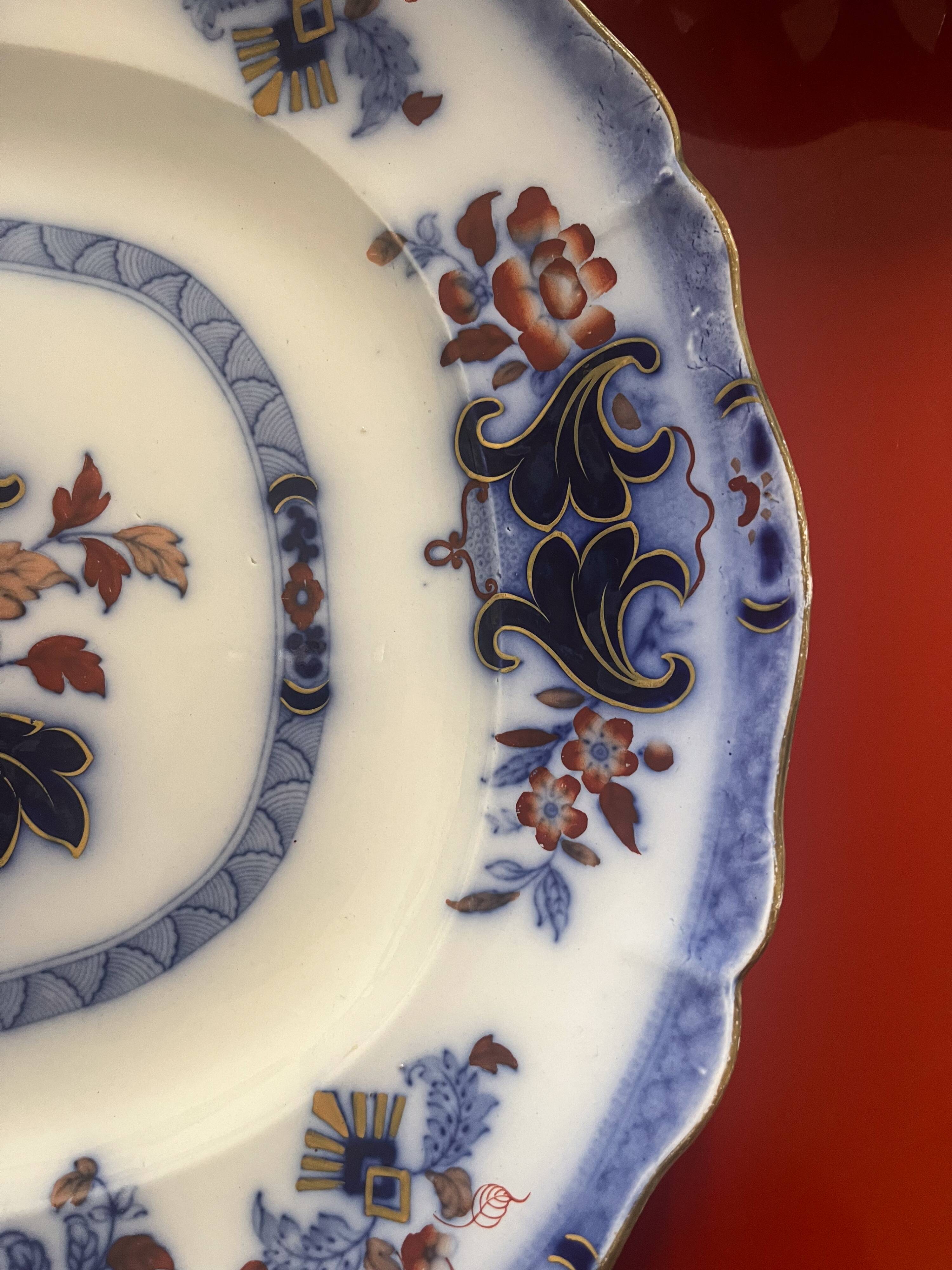 Large hollow dish in fine earthenware with Japanese decoration.
