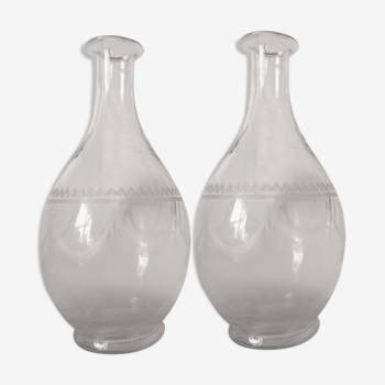 2 old carafes made of worked glass