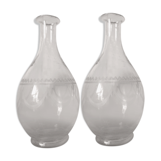 2 old carafes made of worked glass