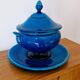 Blue ceramic soup tureen and crackled finish trivet.