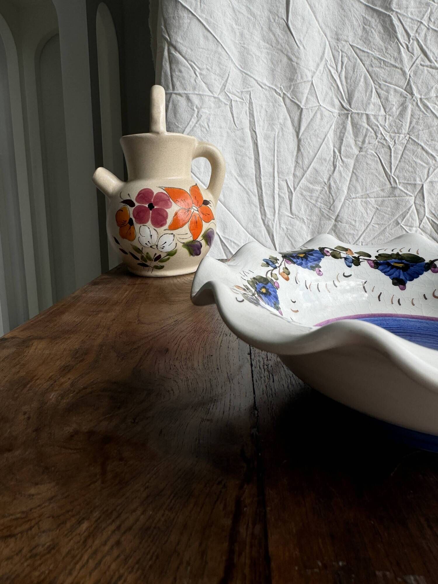 Small hand-painted earthenware salad bowl with garland of blue flowers, mark below
