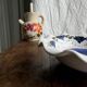 Small hand-painted earthenware salad bowl with garland of blue flowers, mark below