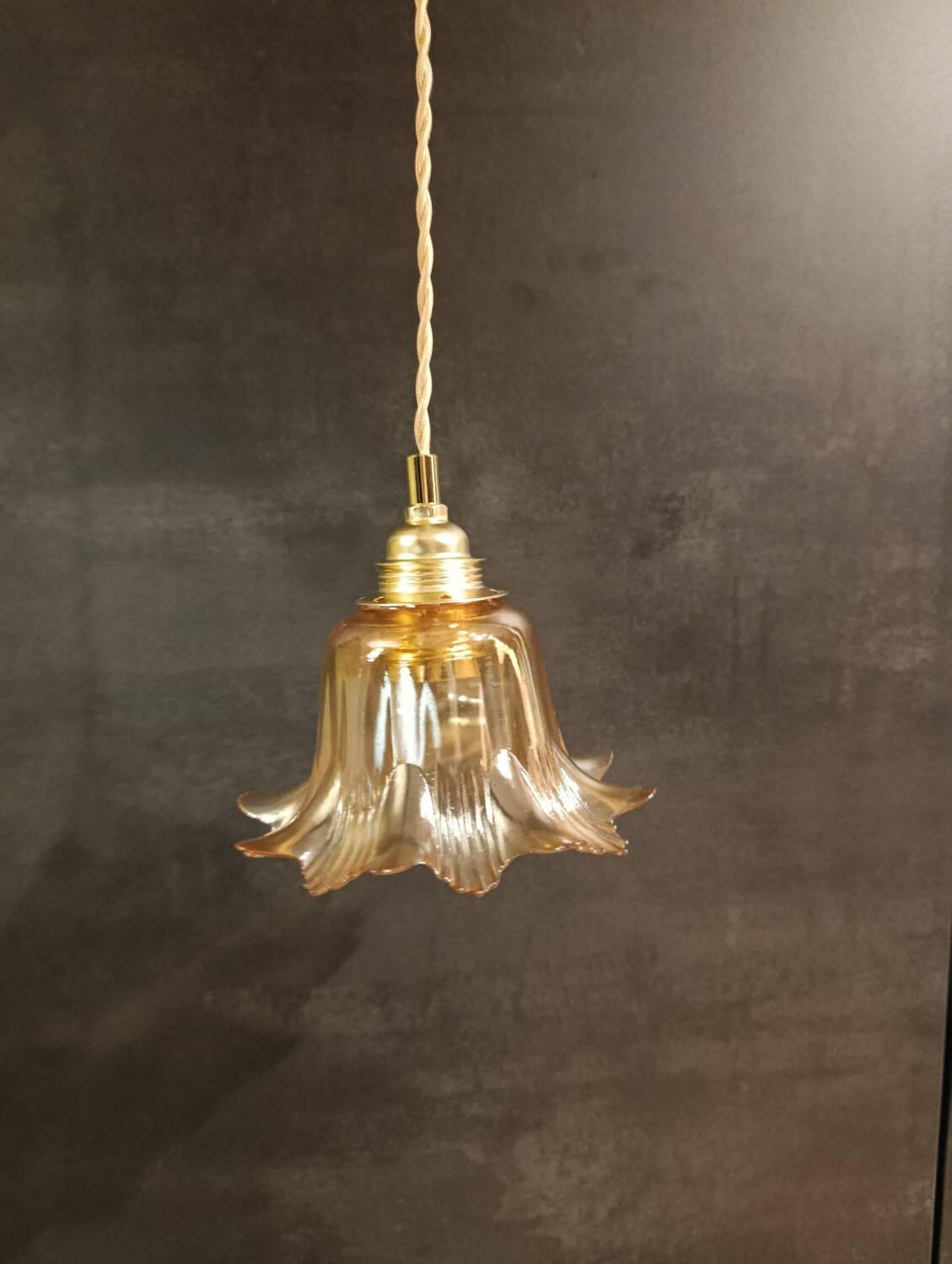 Amber tulip glass portable lamp, golden braided cord.