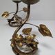 Pair of brass candle holders decorated with patinated metal flowers