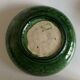 Shallow dish Aegitna on a green glazed earthenware base