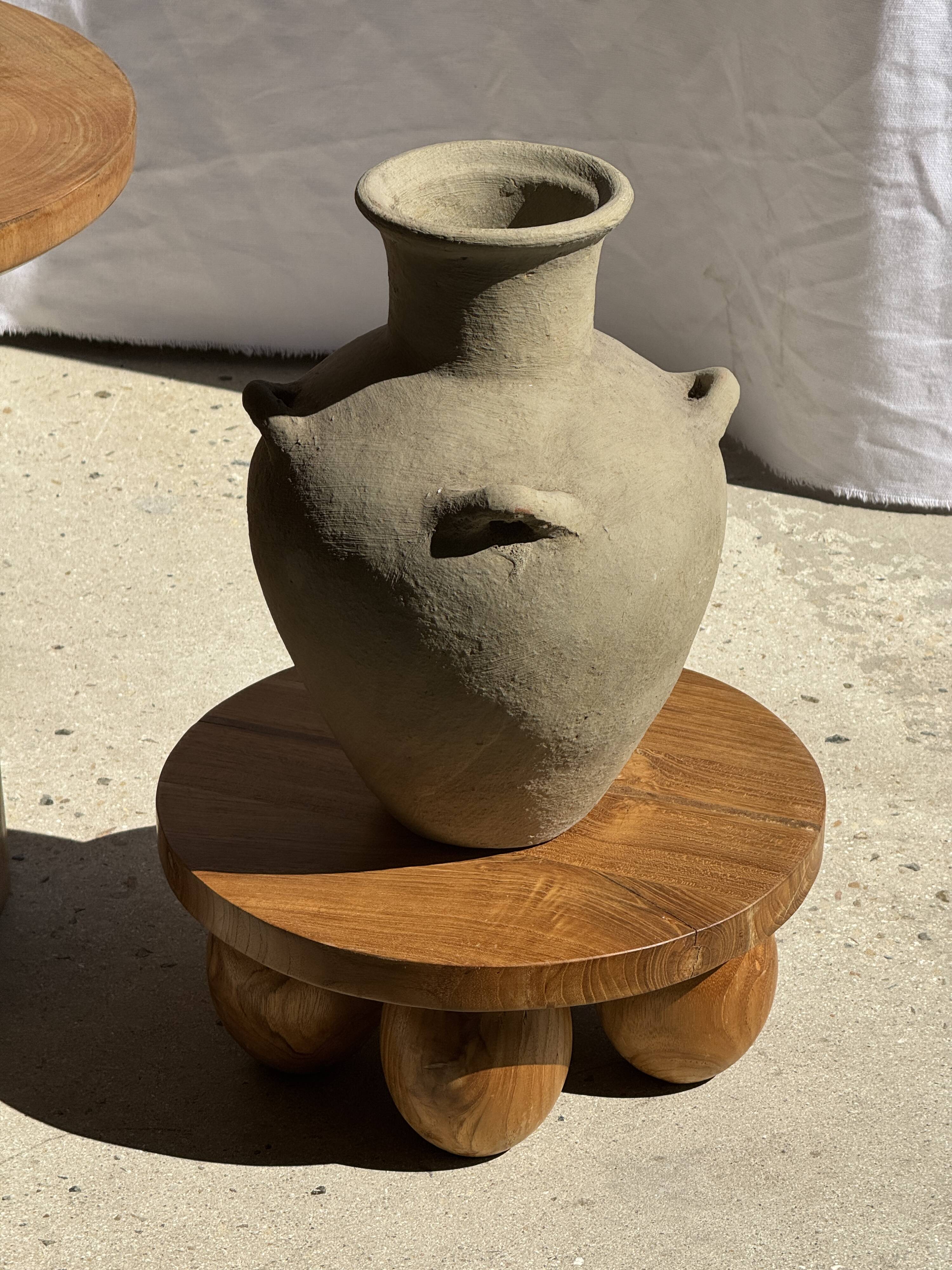 Light beige-grey Indonesian terracotta vase with 4 small handles and a high neck.