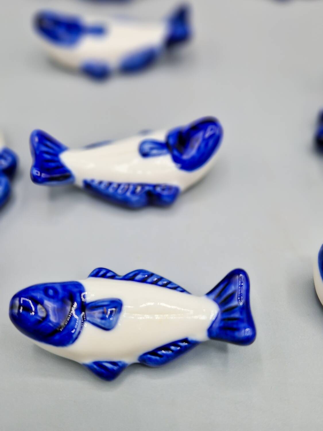 Set of 11 vintage blue and white porcelain fish knife rests.