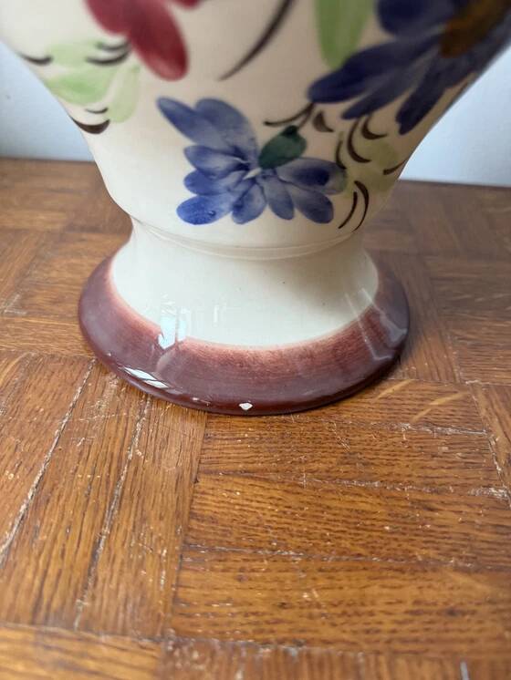 Ceramic vase with hand-painted floral decoration.