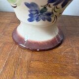 Ceramic vase with hand-painted floral decoration.