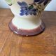 Ceramic vase with hand-painted floral decoration.