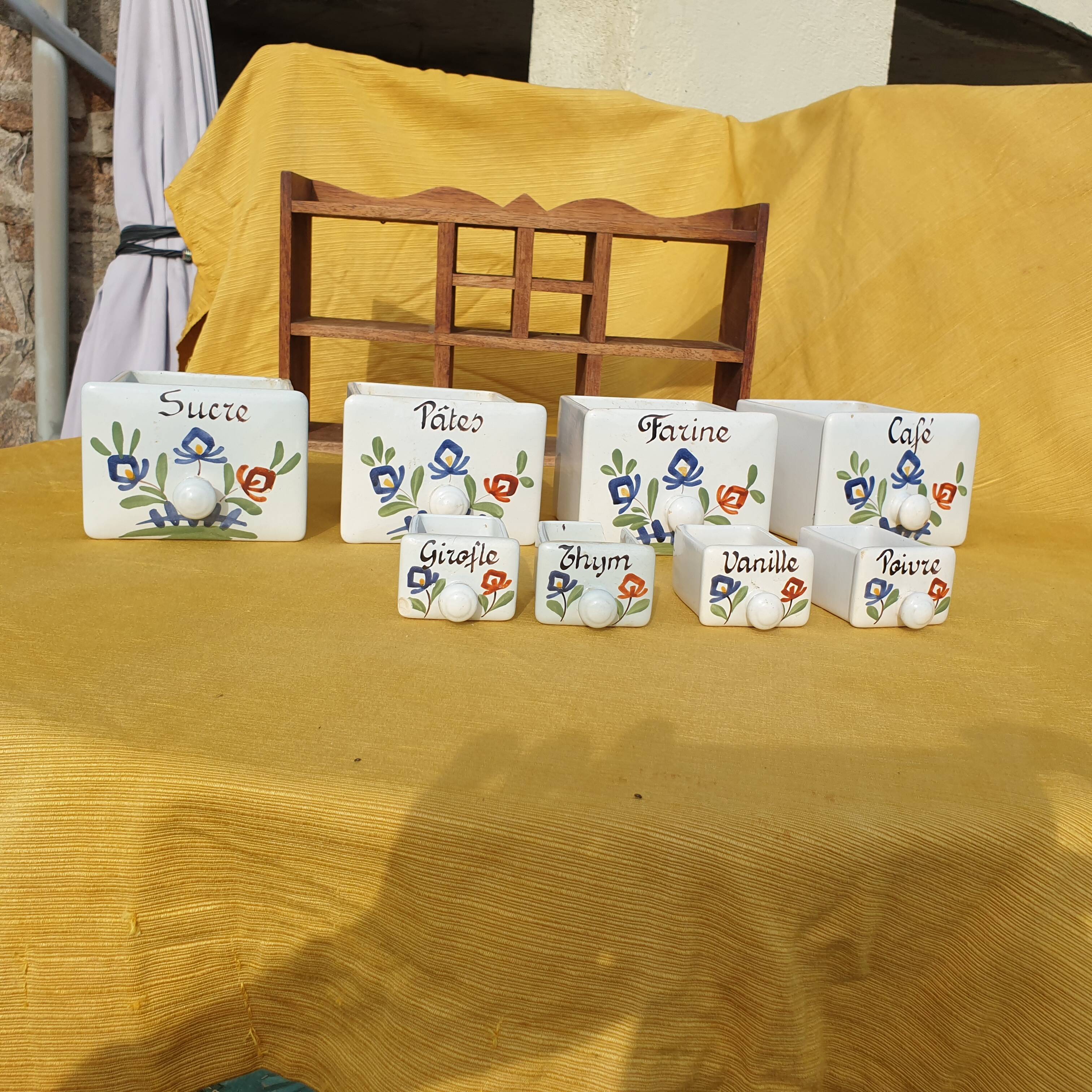 Vintage wooden spice rack with ceramic drawers