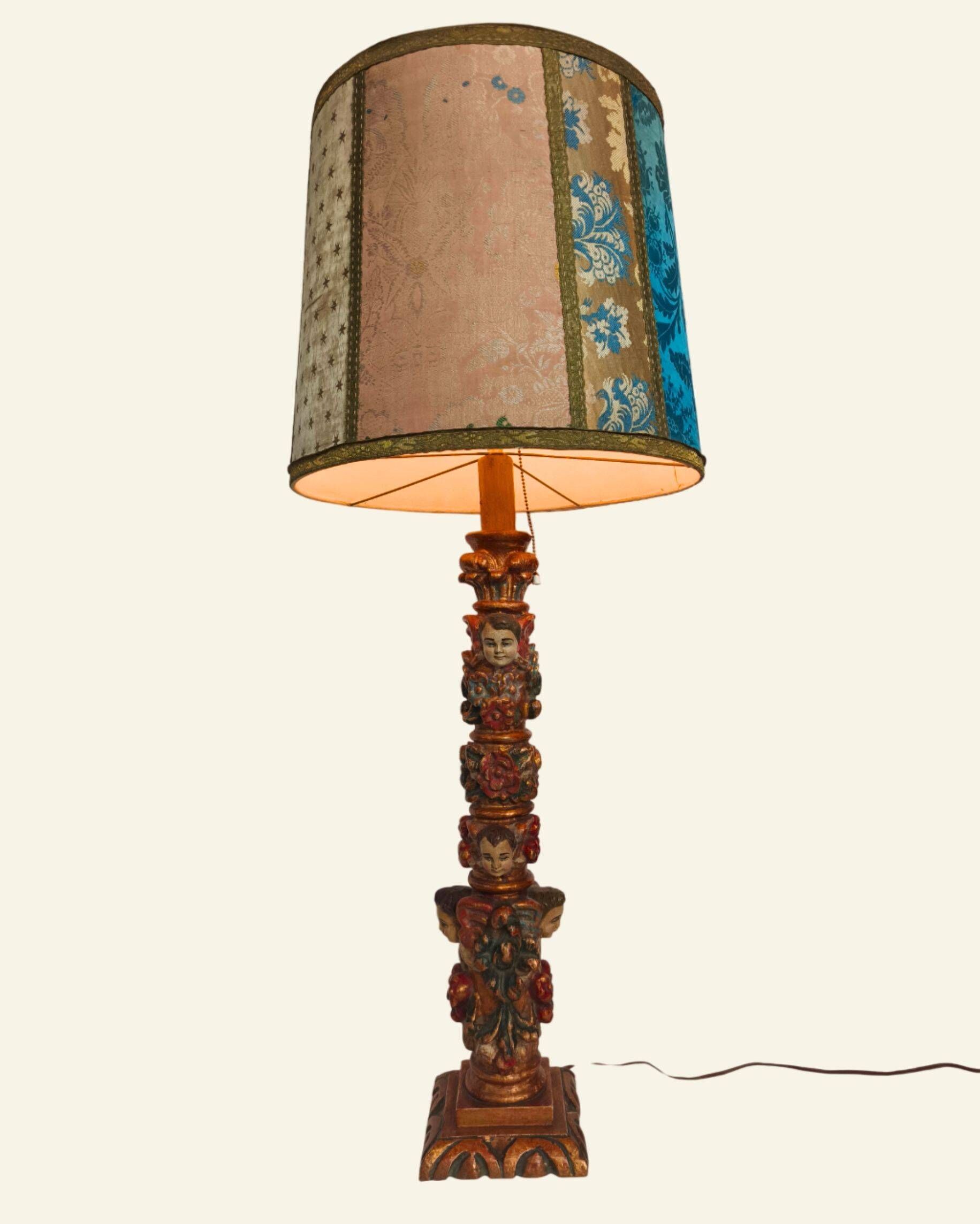 Renaissance table lamp in polychrome carved wood with cherubs.