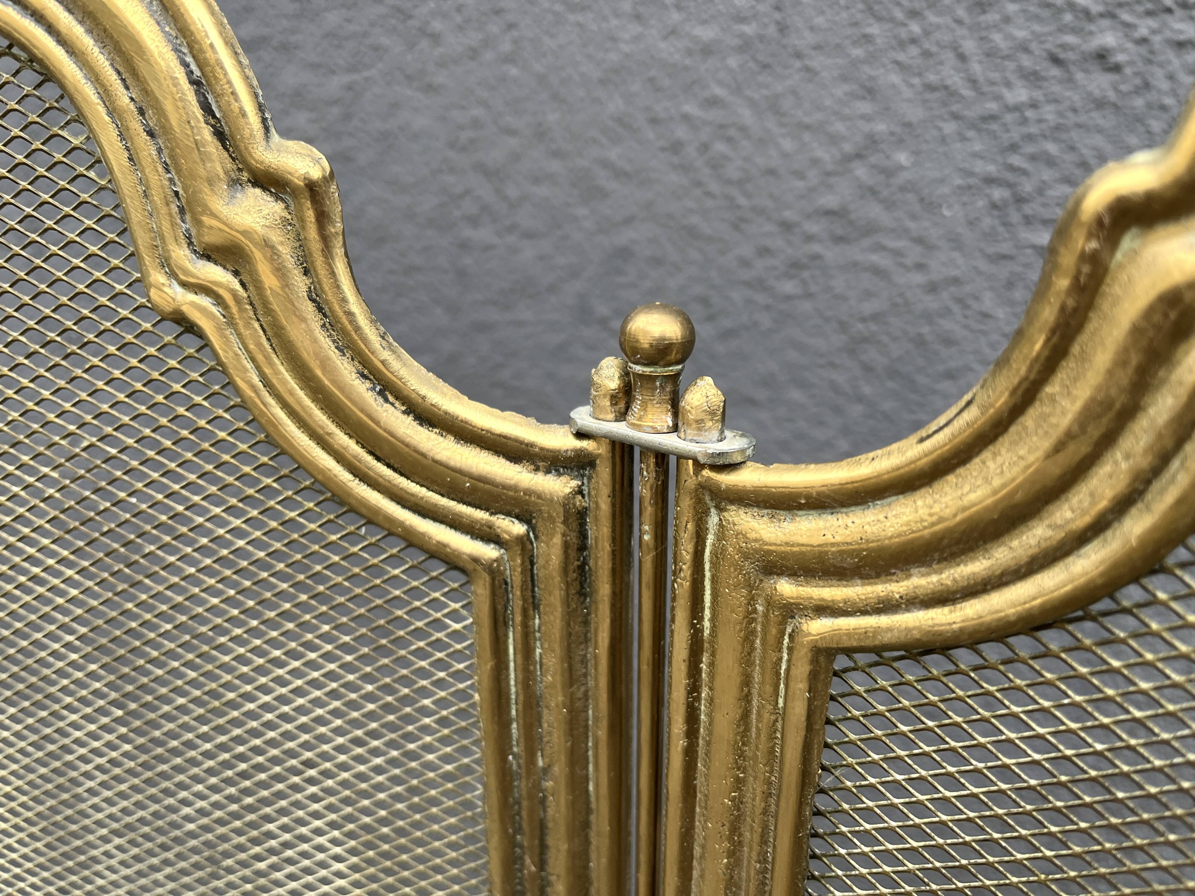 Antique brass fireplace screen from 1920, vintage spark guard.