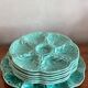 Flat oyster service and 6 splash plates of Gien green celadon