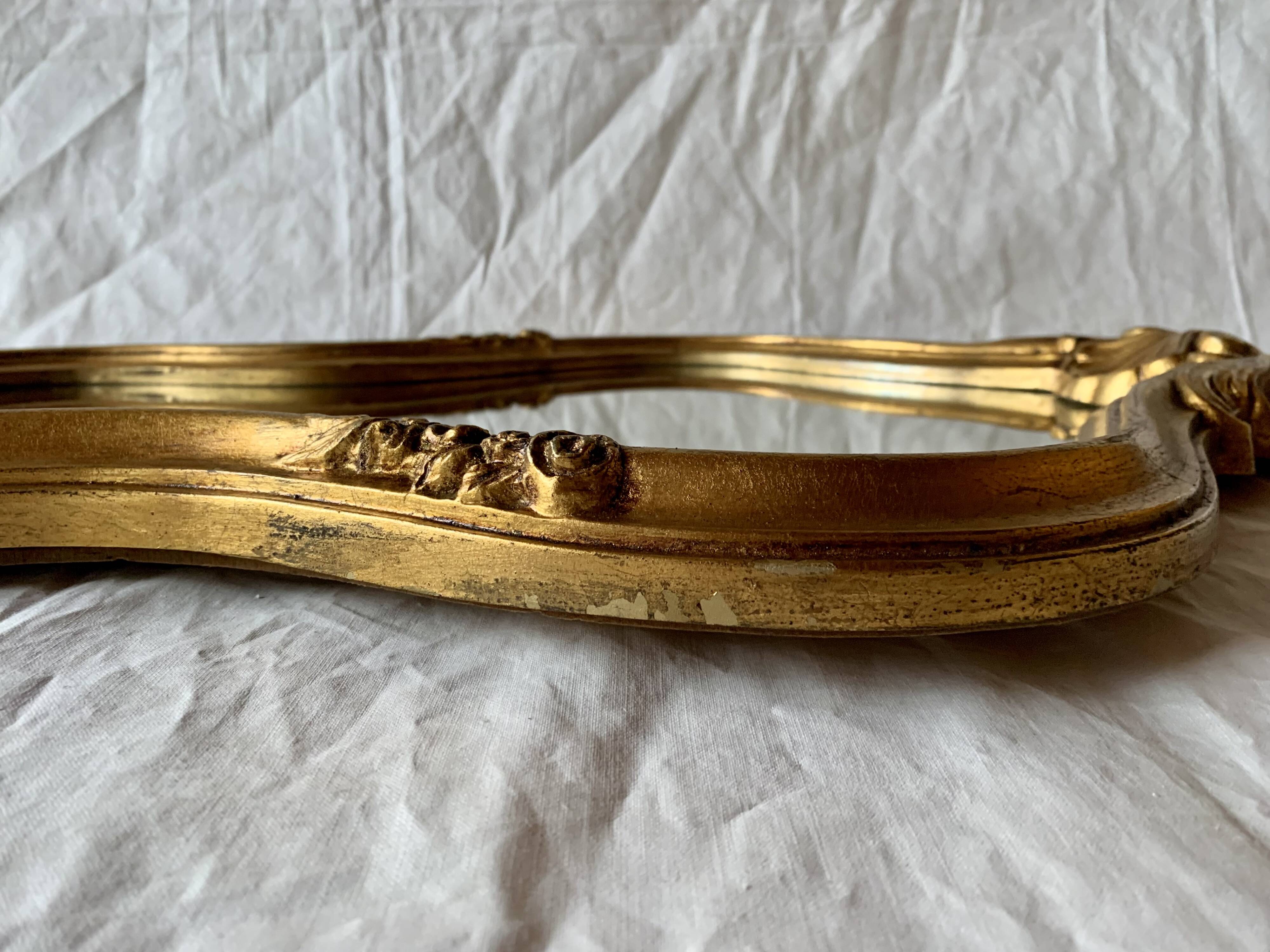 Large rococo mirror in gilded wood