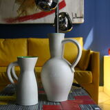 White ceramic pitcher with green background