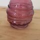 Vintage pink pressed glass carafe – retro decorative bottle with wooden stopper.