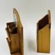 Wall-mounted egg cup holder and wooden utensil holder.
