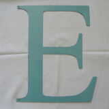 Old letter E painted metal sign