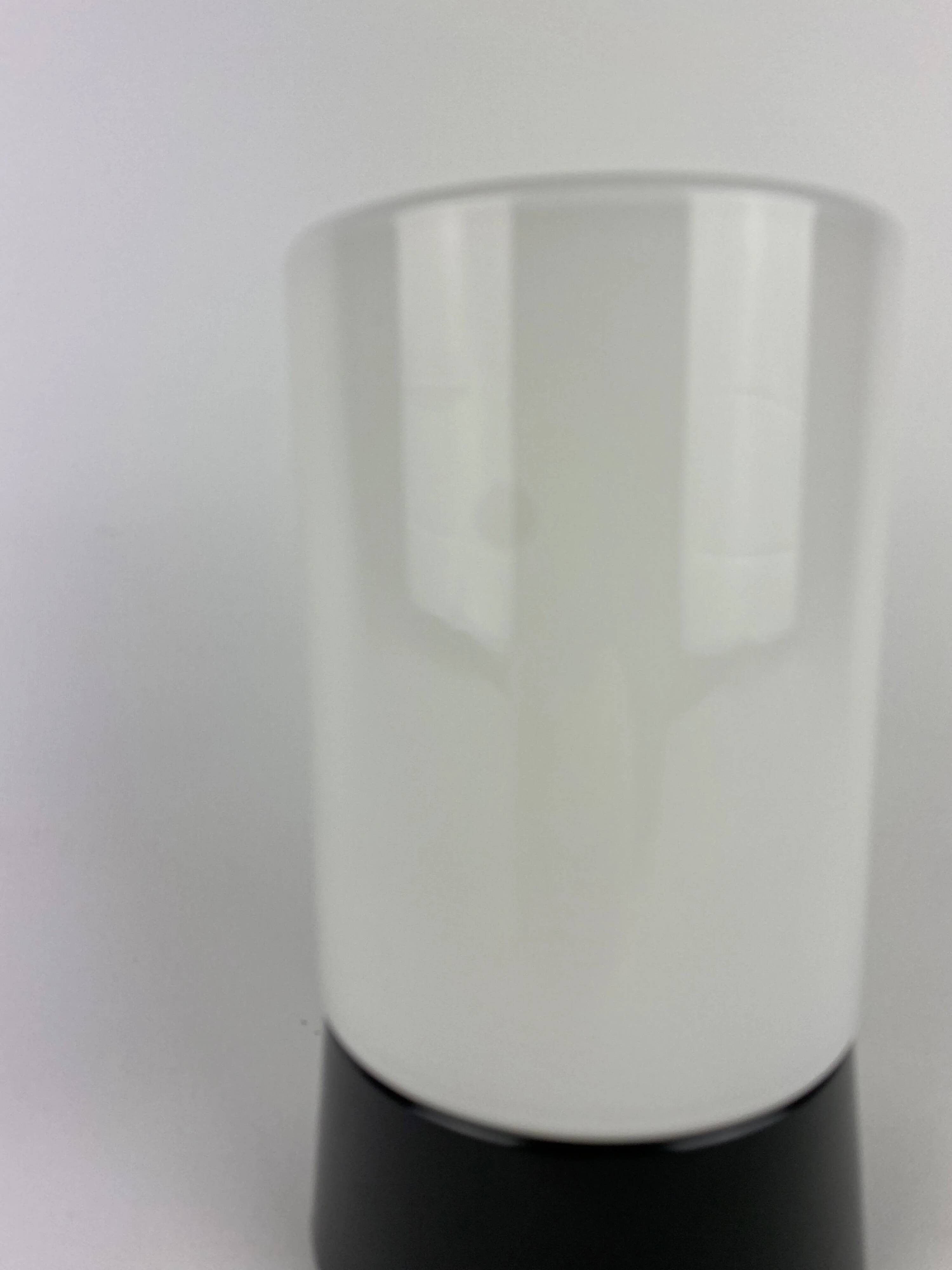 White cylindrical Art Deco chandelier RAAK with black support.