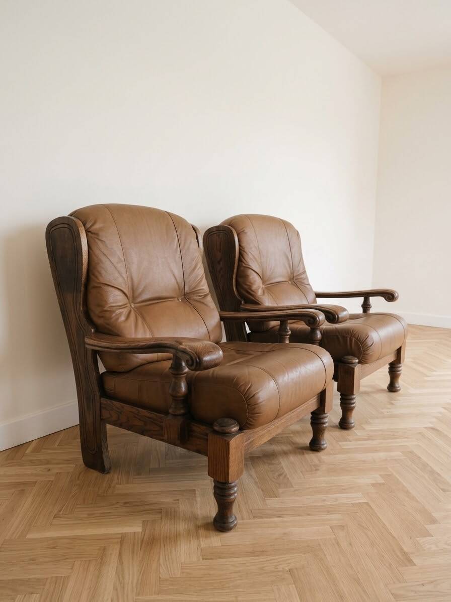 Pair of vintage 1970s armchairs in solid oak and cognac faux leather.