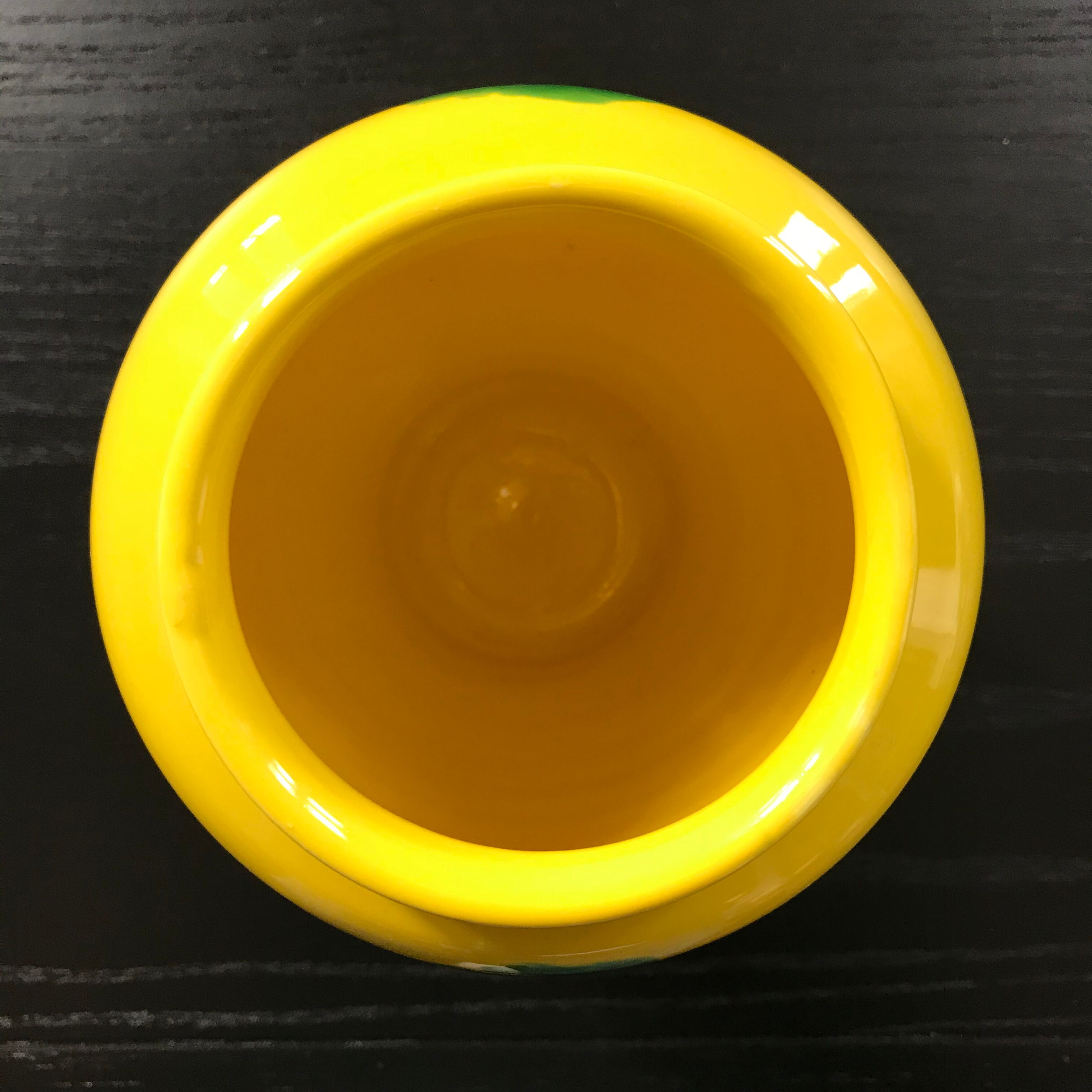 Yellow vase with green spots.