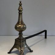 Pair of chiselled bronze and wrought iron fire dogs in the Louis XVI style.