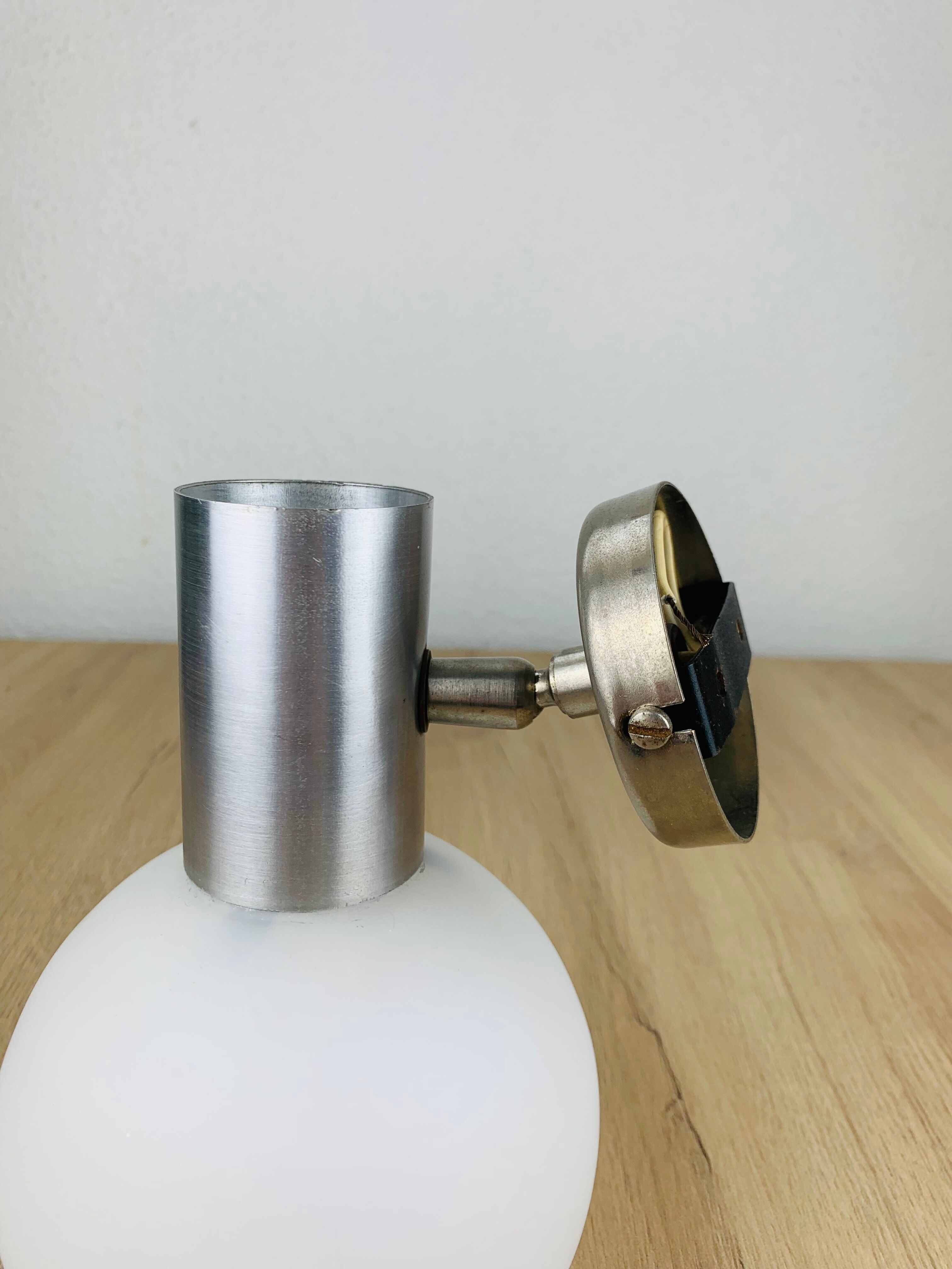 Space age opaline globe wall light, adjustable, and brushed metal, 1960s.