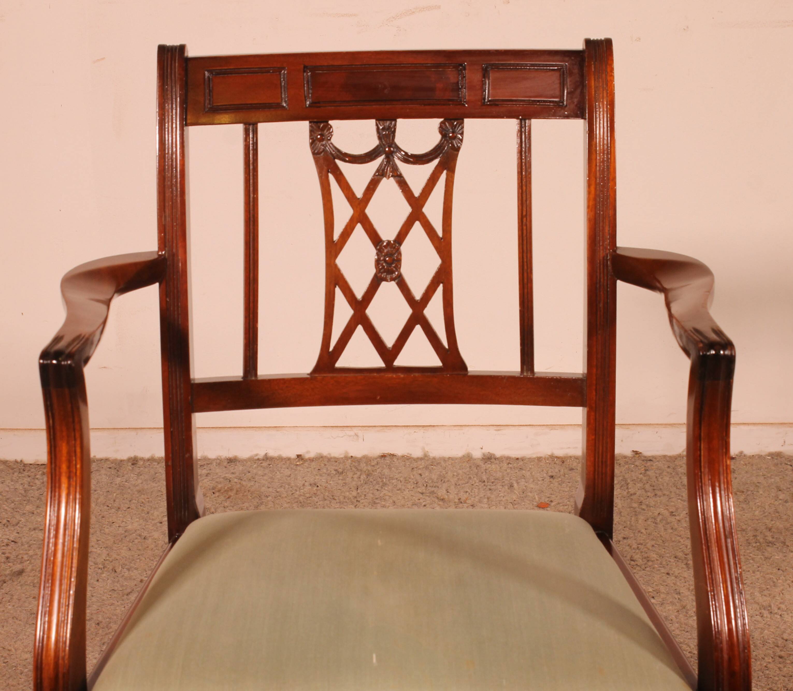 set of 10 chairs and two mahogany armchairs in Hepplewhite style