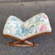 Kneeling prayer desk with rocking footrest in solid wood, curule style & floral fabric.