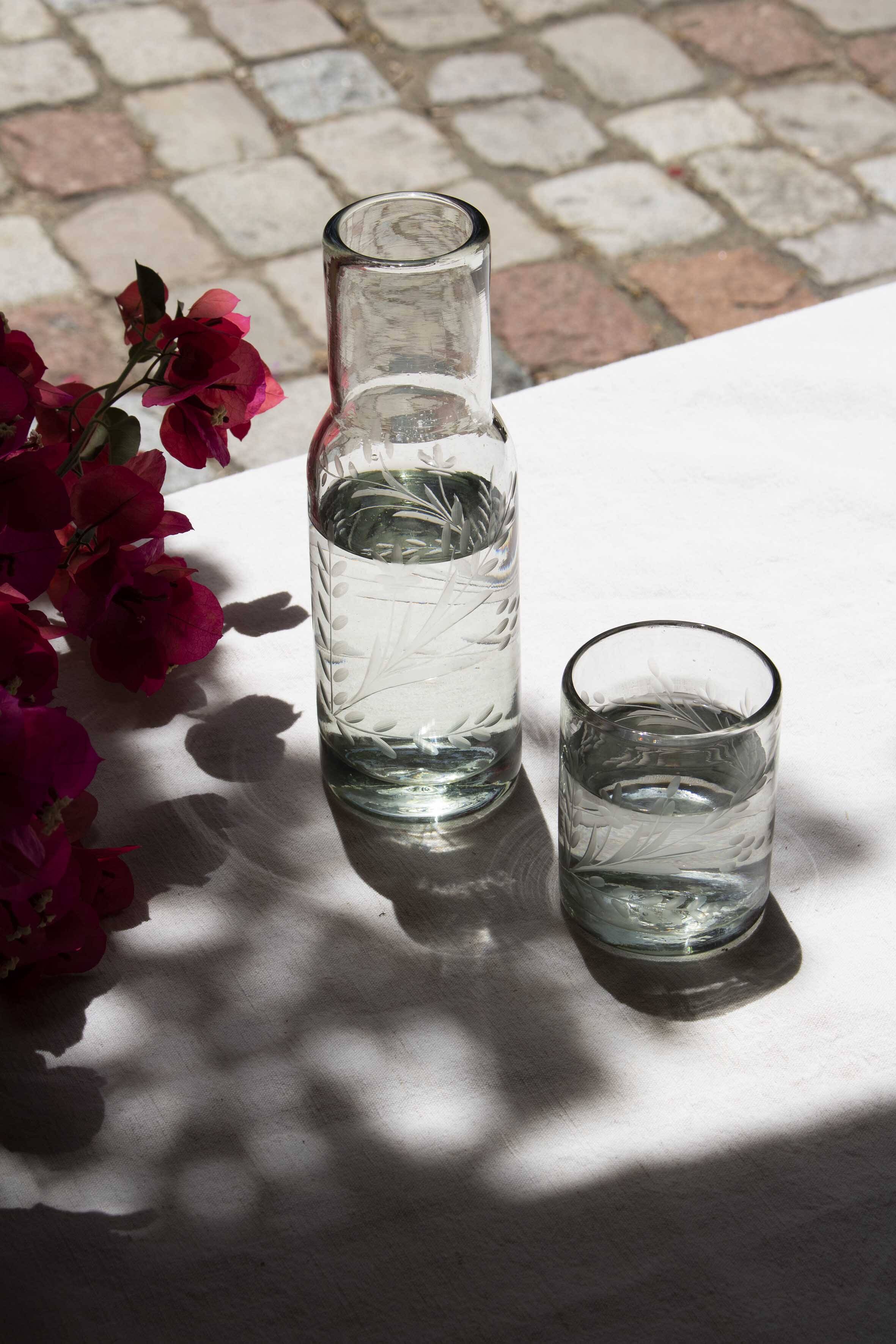 Carafe and glass made of blown and engraved glass.